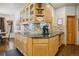 Well-appointed kitchen featuring custom cabinetry, granite countertops, and stone backsplash at 20190 Deer Shadow Way, Monument, CO 80132