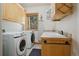 Laundry room area complete with a washer, dryer, sink, countertop, and plenty of cabinet storage at 20190 Deer Shadow Way, Monument, CO 80132