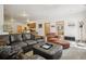Spacious living room with leather furniture and view into the kitchen at 20190 Deer Shadow Way, Monument, CO 80132