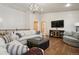 Spacious living room with comfortable seating, wood floors, and a flat-screen television at 20190 Deer Shadow Way, Monument, CO 80132