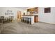 Living room featuring a small bar area, dining table and neutral colored carpet at 20190 Deer Shadow Way, Monument, CO 80132