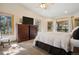 Bright main bedroom featuring an upholstered bed frame, windows with wooded views, and a ceiling fan at 20190 Deer Shadow Way, Monument, CO 80132