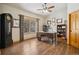 Home office with hardwood floors, ceiling fan, and a large window showcasing beautiful views of the landscape at 20190 Deer Shadow Way, Monument, CO 80132