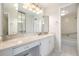 Bright bathroom features vanity and tiled shower and tub at 955 Eudora St # 207E, Denver, CO 80220