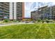 Beautifully landscaped community area featuring a pergola, seating, and lush green lawn at 955 Eudora St # 207E, Denver, CO 80220