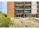 Building exterior featuring private patios with glass sliding doors and a well-maintained landscape at 955 Eudora St # 207E, Denver, CO 80220