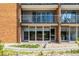 Exterior building view, showcasing the private outdoor terrace with glass sliding doors at 955 Eudora St # 207E, Denver, CO 80220