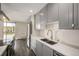 Modern kitchen features stainless steel appliances, gray cabinets, and hardwood floors at 955 Eudora St # 207E, Denver, CO 80220