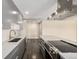 Modern kitchen features stainless steel appliances, gray cabinets, and hardwood floors at 955 Eudora St # 207E, Denver, CO 80220