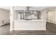 Kitchen island featuring stainless steel appliances, grey cabinetry, hardwood floors, and a quartz countertop at 955 Eudora St # 207E, Denver, CO 80220