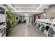 Clean community laundry room with multiple washers and dryers for resident use at 955 Eudora St # 207E, Denver, CO 80220