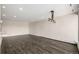 Spacious living room with hardwood floors, recessed lighting, and a stylish industrial chandelier at 955 Eudora St # 207E, Denver, CO 80220