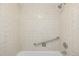 Shower and tub with tiled walls and grab bar at 955 Eudora St # 207E, Denver, CO 80220