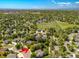 Aerial view of a neighborhood with mature trees, a park, and mountain views at 10859 Irving Ct, Westminster, CO 80031