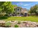 Extensive backyard featuring a landscaped garden and a spacious patio with an outdoor dining area at 10859 Irving Ct, Westminster, CO 80031