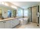 Primary bathroom suite includes double vanity, soaking tub, and luxurious tile walk-in shower at 10859 Irving Ct, Westminster, CO 80031