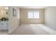 Bright, carpeted bedroom with a view of the connected bathroom's granite vanity and shower at 10859 Irving Ct, Westminster, CO 80031