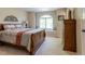 Cozy bedroom features a window seat, a large bed, and a wooden dresser at 10859 Irving Ct, Westminster, CO 80031