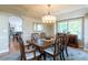 Traditional dining room with a wood table, elegant chandelier, and a large window providing natural light at 10859 Irving Ct, Westminster, CO 80031