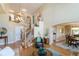 Grand foyer with a curved staircase, wood floors, and views to the dining room and upper level at 10859 Irving Ct, Westminster, CO 80031