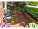 Charming brick patio features wicker chairs with turquoise cushions, creating a cozy outdoor seating area at 10859 Irving Ct, Westminster, CO 80031