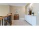 Upstairs hallway features plush carpeting, iron railing, and cabinet and display shelving at 10859 Irving Ct, Westminster, CO 80031