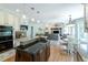 Open concept kitchen with dual islands, stainless appliances and hardwood floors leading to a seating area at 10859 Irving Ct, Westminster, CO 80031