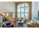 Bright living room with a soaring window, comfortable seating, and views to the adjacent dining area at 10859 Irving Ct, Westminster, CO 80031