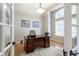 Well-lit office space with large desk, hardwood floors, and an abundance of natural light at 10859 Irving Ct, Westminster, CO 80031