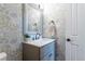 Charming powder room with leaf wallpaper, granite sink vanity, and decorative mirror at 10859 Irving Ct, Westminster, CO 80031