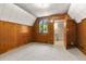 Carpeted bedroom featuring wood paneled walls and a window overlooking trees at 422 Fairview Blvd, Breckenridge, CO 80424