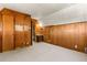 Carpeted bedroom featuring wood paneled walls, and a door to a bathroom at 422 Fairview Blvd, Breckenridge, CO 80424