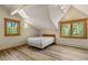 Inviting bedroom with vaulted ceilings, two windows, and wood-look flooring, offering a bright and airy space at 422 Fairview Blvd, Breckenridge, CO 80424