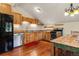 Modern kitchen featuring wood cabinets, stainless steel appliances, and hardwood floors beneath a vaulted ceiling at 422 Fairview Blvd, Breckenridge, CO 80424