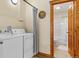 Laundry area with washer, dryer, and direct access to a full bathroom, all adjacent to a rustic wooden doorframe at 422 Fairview Blvd, Breckenridge, CO 80424