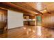 Open-concept living space with hardwood floors, wooden beams, and a cozy kitchen area with natural light at 422 Fairview Blvd, Breckenridge, CO 80424