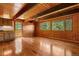 Bright and airy living room featuring hardwood floors, wood-paneled walls, and large windows with a view at 422 Fairview Blvd, Breckenridge, CO 80424