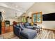 Open living room and kitchen with hardwood floors and wooded views from the windows at 422 Fairview Blvd, Breckenridge, CO 80424