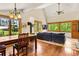 Bright, open living room with hardwood floors, vaulted ceilings, numerous windows, and a wood-burning stove at 422 Fairview Blvd, Breckenridge, CO 80424