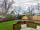 Picturesque backyard view from a wooden deck, showcasing lush greenery, a fence, and a tranquil setting at 5886 Urban St, Arvada, CO 80004