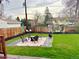 Backyard with a lush lawn, a fire pit area, and a seating area for relaxation and entertainment at 5886 Urban St, Arvada, CO 80004