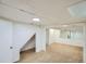 Bright basement featuring new carpet, staircase and storage closet at 5886 Urban St, Arvada, CO 80004