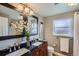 Bathroom with double sinks, granite countertop, and an elegant vanity at 5886 Urban St, Arvada, CO 80004