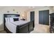 Comfortable bedroom with a sleigh bed, ceiling fan, and large sliding door closet at 5886 Urban St, Arvada, CO 80004