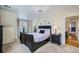 Bright bedroom with carpet, a decorative ceiling fan, and a black sleigh bed with white linens at 5886 Urban St, Arvada, CO 80004