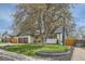 Beautiful home exterior featuring mature trees, green lawn, and a charming facade, creating a welcoming atmosphere at 5886 Urban St, Arvada, CO 80004