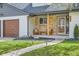 Inviting front porch with stone accents, seating area, and a well-maintained walkway, perfect for relaxing outdoors at 5886 Urban St, Arvada, CO 80004