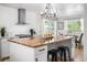 Spacious kitchen with butcher block island, modern lighting, and stainless steel appliances at 5886 Urban St, Arvada, CO 80004