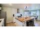 Bright kitchen with stainless steel appliances, a central island, and ample cabinet space, perfect for cooking and entertaining at 5886 Urban St, Arvada, CO 80004