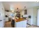 Bright, open kitchen with a large island, stainless steel appliances, and white cabinets at 5886 Urban St, Arvada, CO 80004